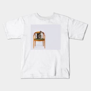 a cat on a chair Kids T-Shirt